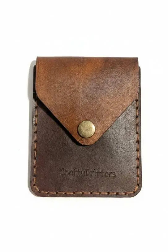Handmade brown leather card holder with a vintage snap closure.