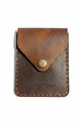Handmade brown leather card holder with a vintage snap closure.