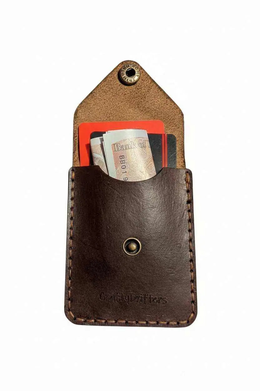 Handmade dark brown leather card holder with cash and cards inside.
