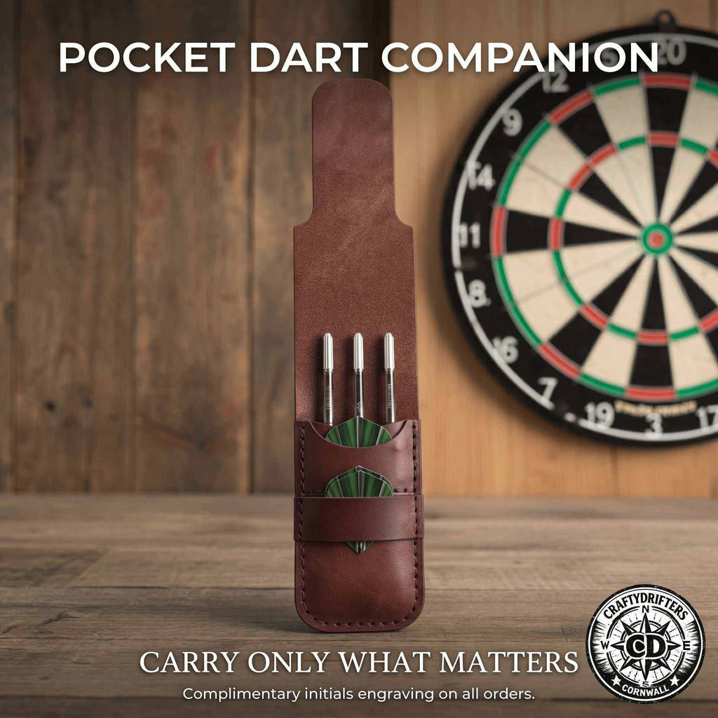 Handmade brown leather dart case holding three silver darts with green flights.