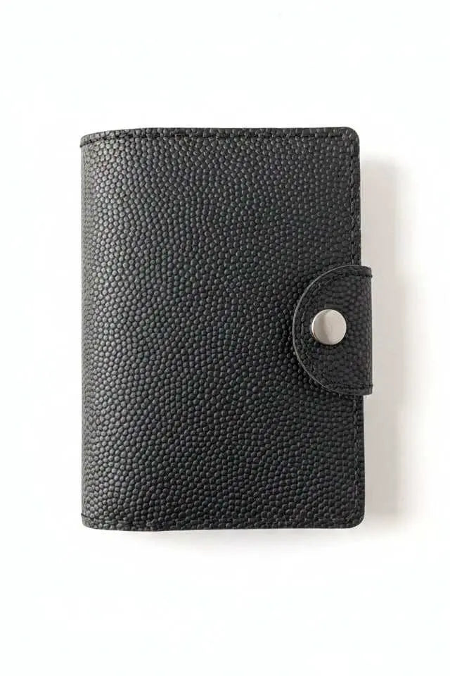 Handmade black pebbled leather passport cover with a silver snap closure