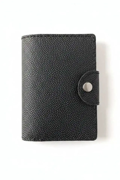 Handmade black pebbled leather passport cover with a silver snap closure