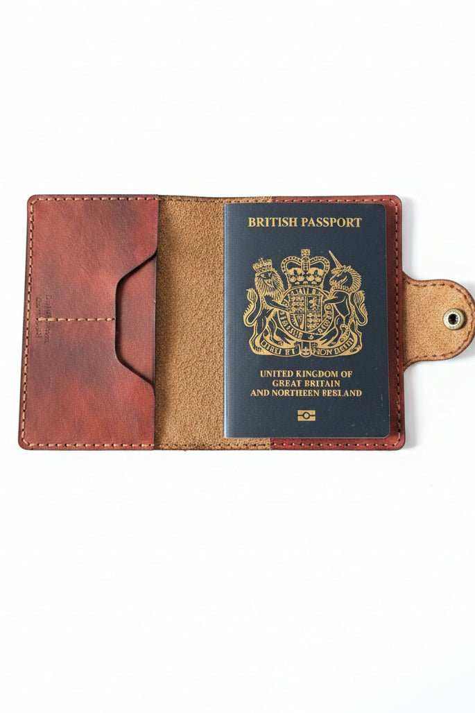 Handmade brown leather passport cover holding a British passport.