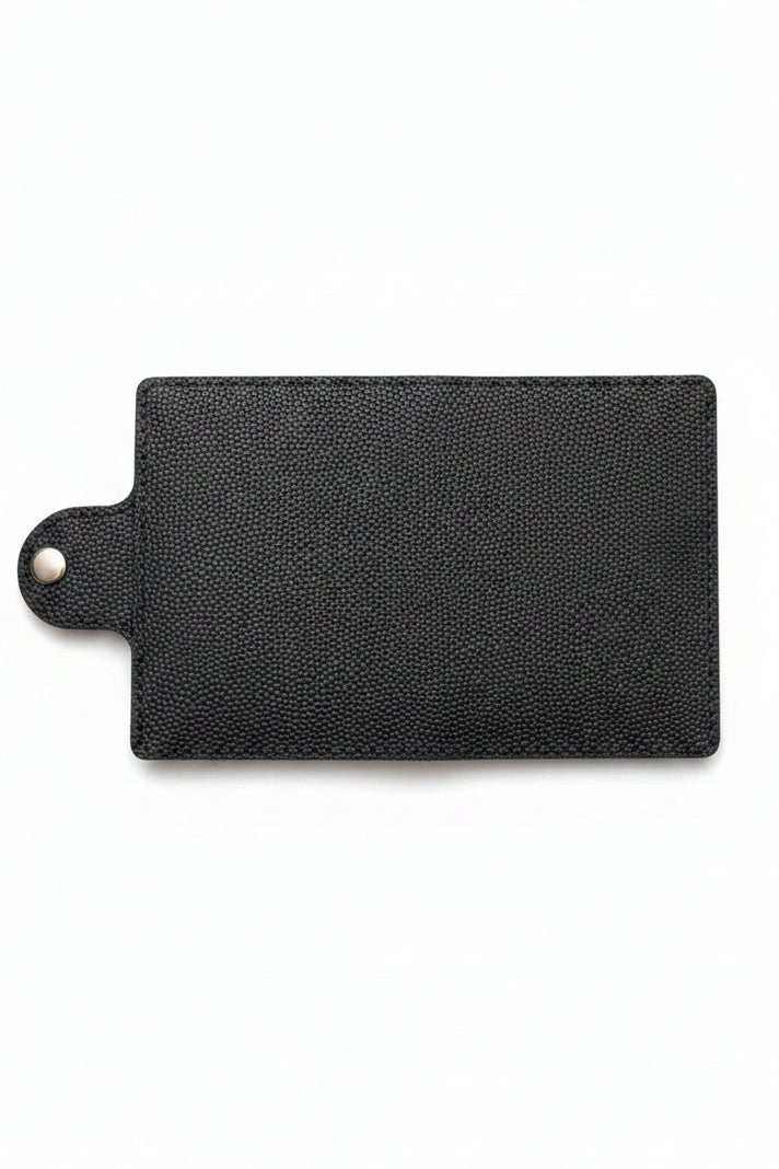 Handmade black pebbled leather passport cover with a snap button closure