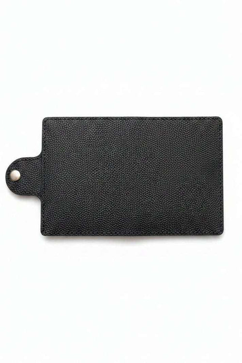 Handmade black pebbled leather passport cover with a snap button closure