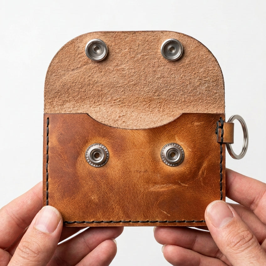 Tan leather keyring card and cash purse with flap open, showing the snap fasteners