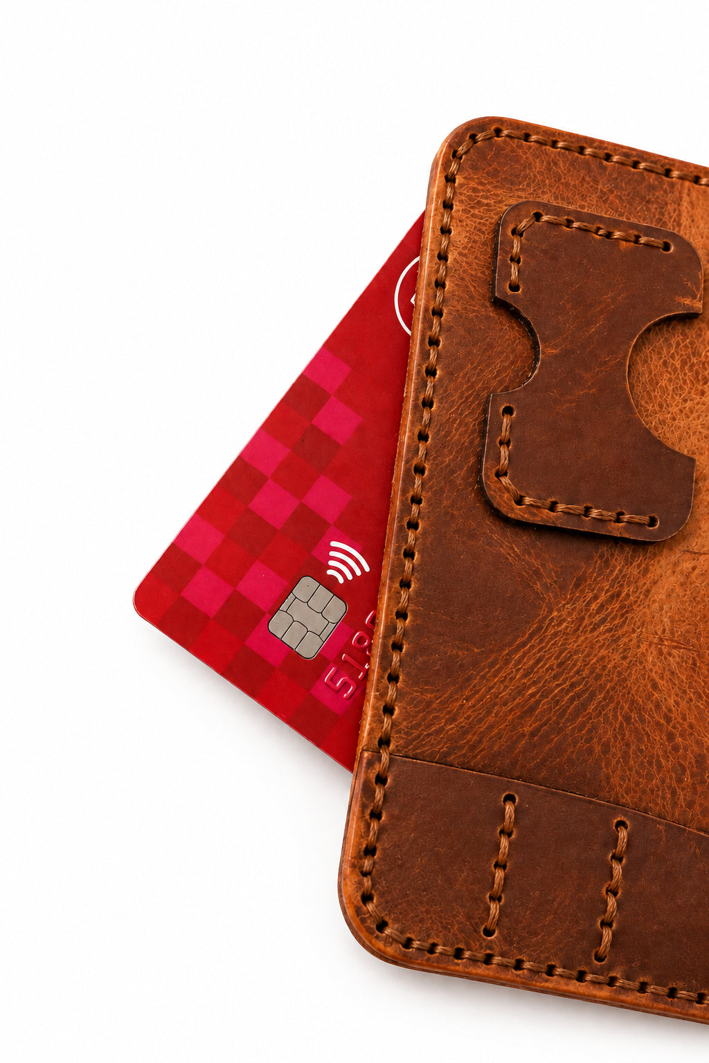 Close-up of the tan leather darts case pocket with a red bank card