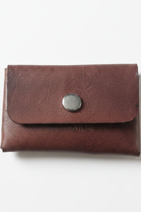 Stitch-free leather coin purse closed with a snap, on a white background