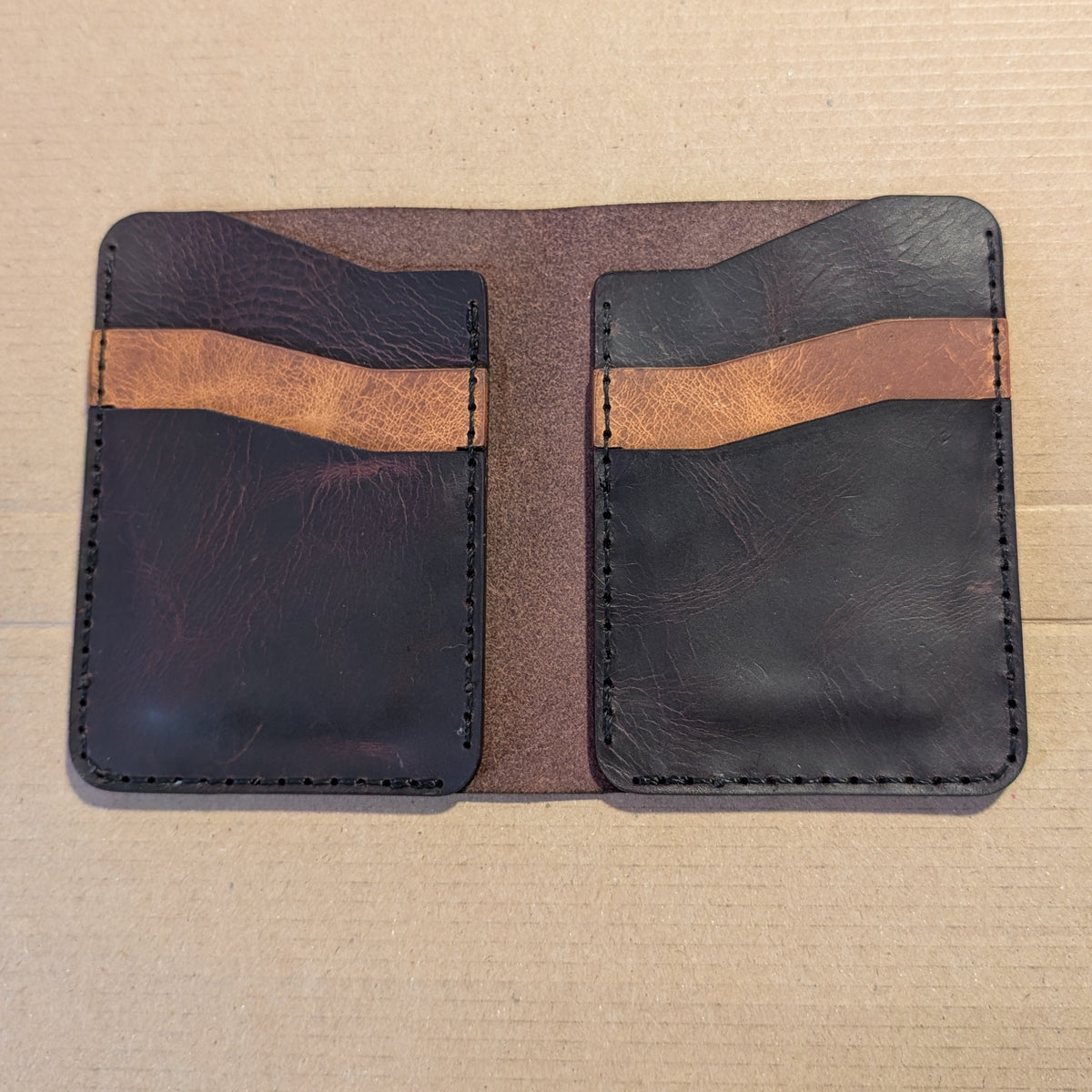 Hilldown Premium bi-fold open and empty, dark leather with tan pocket trim