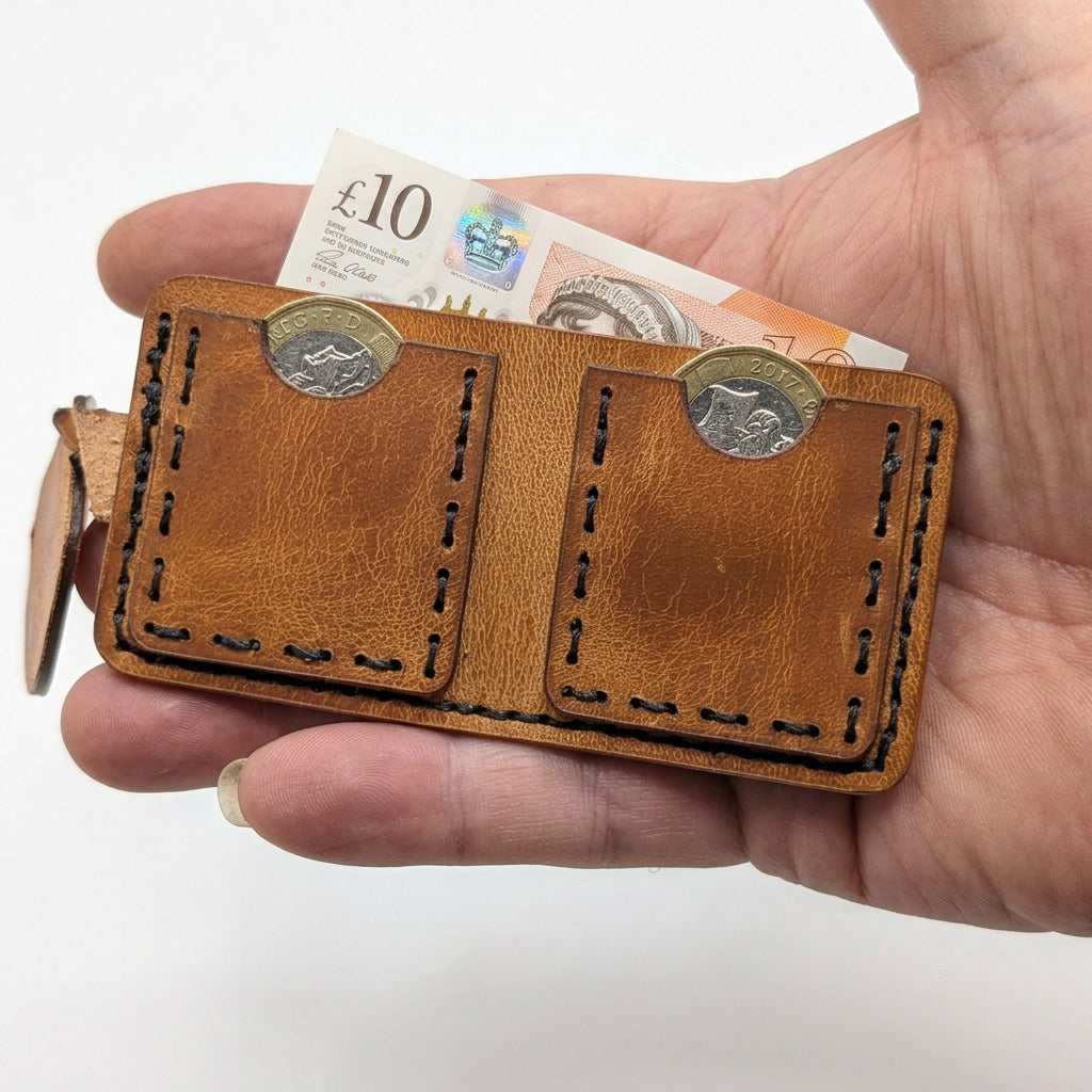 Tan KeyChain Micro Wallet laid open with £1 coins and a folded £10 note