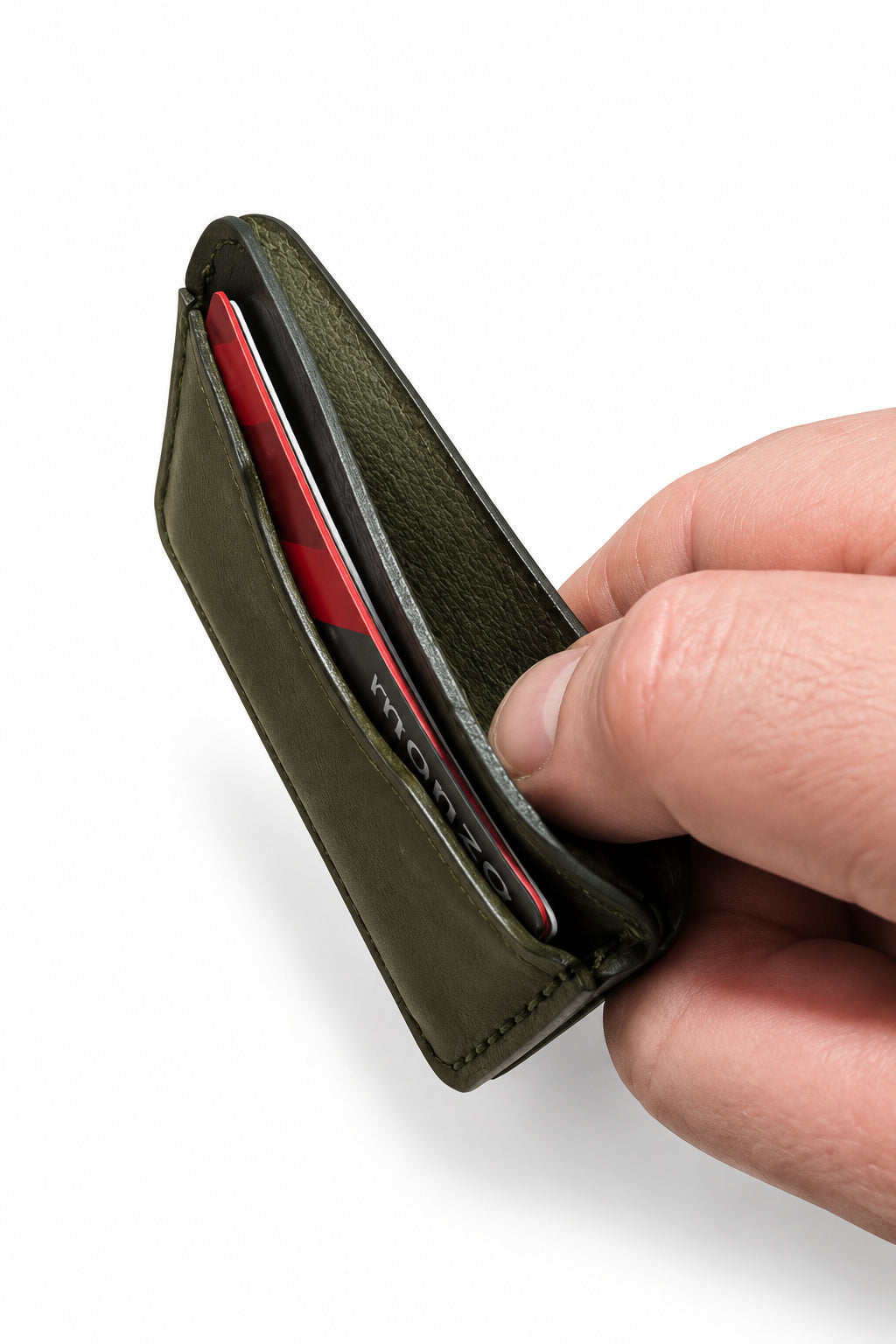 Olive green three-pocket card sleeve held in hand, side view with cards inside