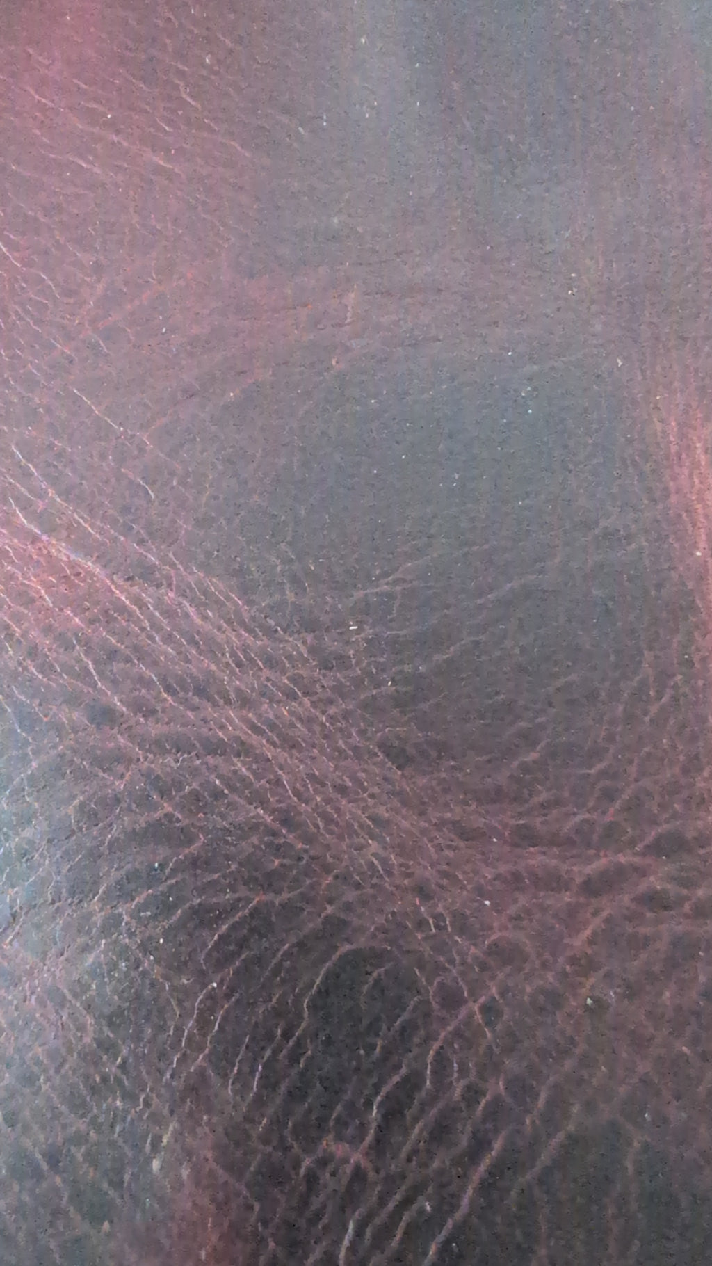 Close-up of reddish-brown leather grain, a leather option for the darts case
