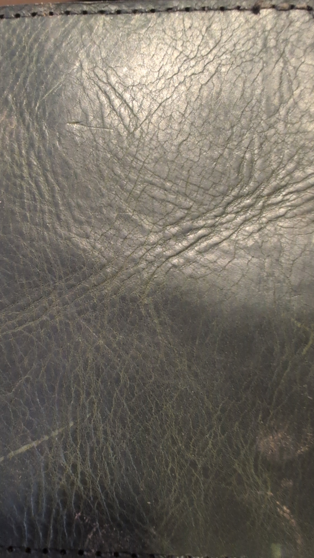 Close-up of dark leather grain, a leather option for the darts case