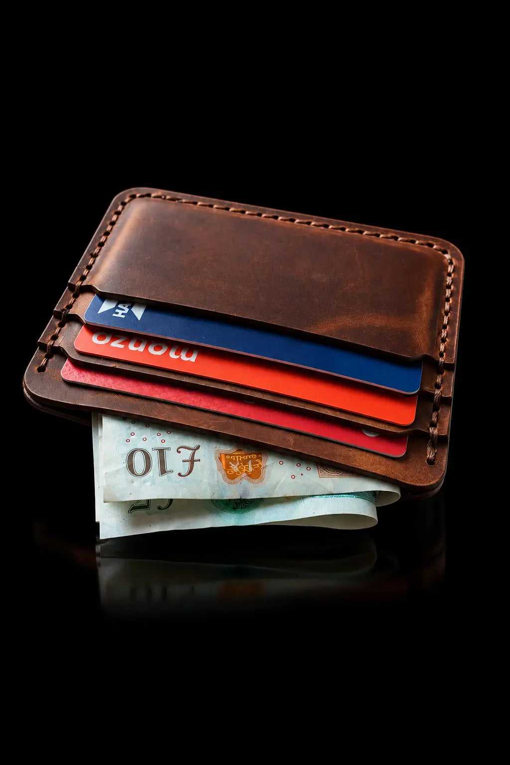 The Beast card sleeve at an angle, showing pockets with cards and banknotes