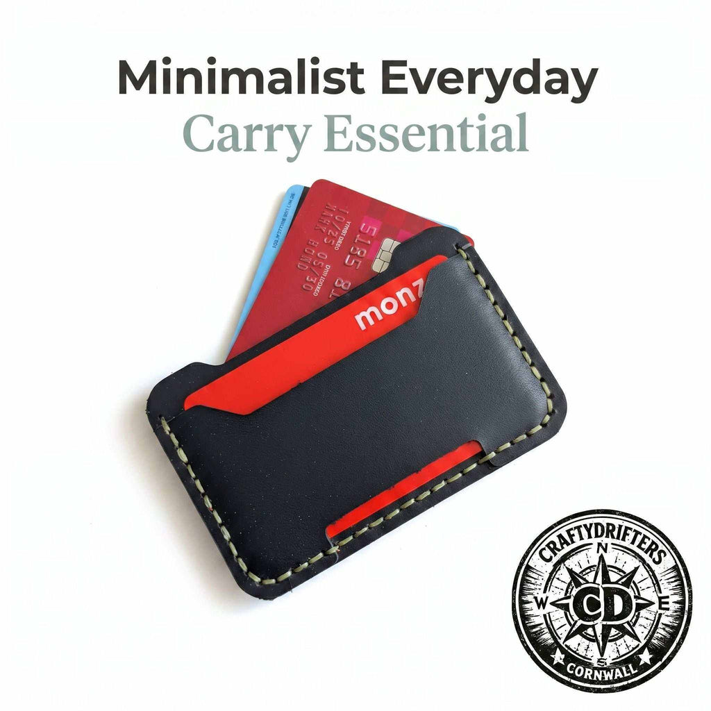 Minimalist black leather card holder with red accents containing credit cards.