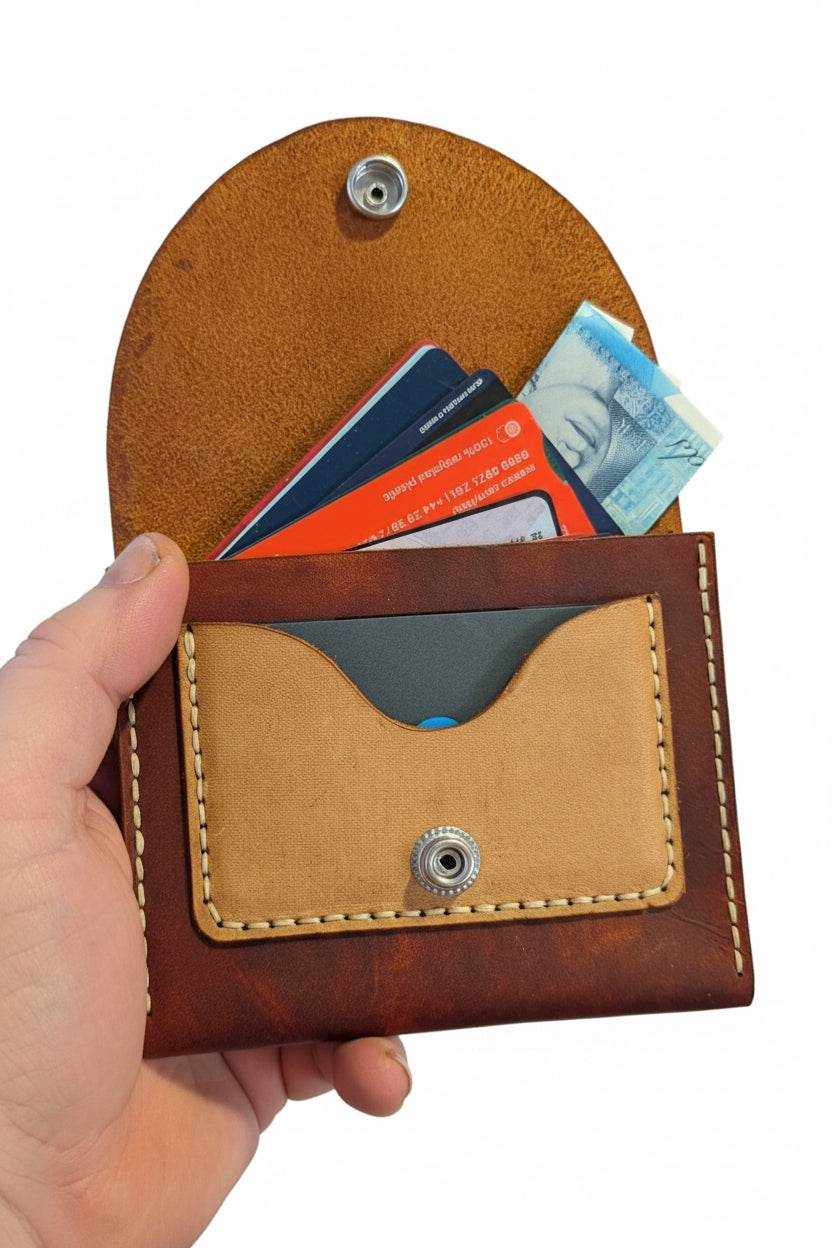 Handmade brown leather coin purse with cards and cash inside