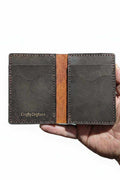 The Fistral bi-fold wallet open, dark leather with tan centre panel and CraftyDrifters stamp