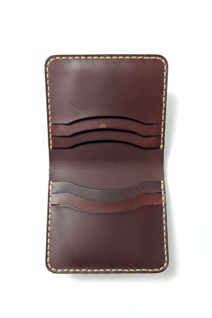 The Grange dark brown leather bi-fold wallet open, showing six card slots and cream stitching